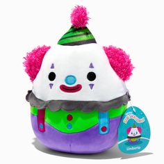 a stuffed toy with a hat on it's head and pom - poms