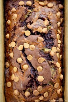 a loaf of chocolate chip banana bread in a baking pan with peanut butter on top