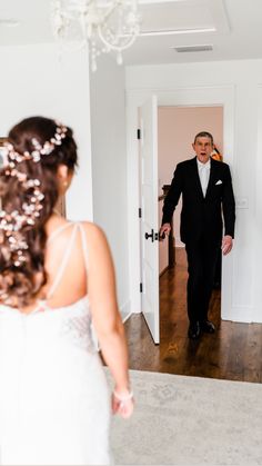 a man in a tuxedo looking at his bride