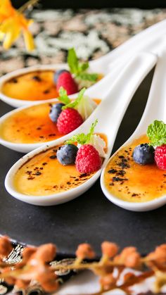 four dessert spoons with fruit on them