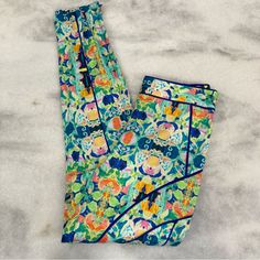 Milly Bright Colorful Tile Print Abstract Patterned Spring Summer Light Weight High Rise Ankle Pant With Contrasting Seam Detail In Silk. Side Zip, Hidden Zippers At Leg. Unlined. Color Tones Of Green, Blue, Orange, Yellow And Pink. New With Tags. Size 4 Waist 14” Across, Rise 10.5”, Inseam 29” Measurements Are Approximate Pictures Are Part Of The Description-Please Zoom In. Ask If You Have Any Questions. Thank You For Checking Out My Closet Shorts Leggings Tan Beige Nude Black White Pink Green Spring Patterned Loungewear Pants, Green Vibrant Print Casual Bottoms, Casual Green Bottoms With Vibrant Print, Printed Bottoms For Summer Pajama Party, Printed Summer Bottoms For Pajama Party, Printed Bottoms For Pajama Party In Summer, Patterned Pants With Elastic Waistband For Spring, Green Bottoms With Vibrant Print For Vacation, Multicolor Floral Print Ankle-length Pants