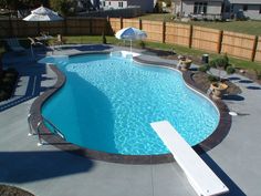 an empty swimming pool in the middle of a backyard