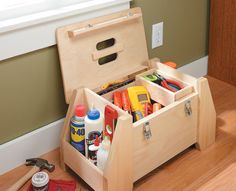 a wooden tool box filled with tools on top of a hard wood floor