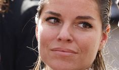 a close up of a woman with braids on her hair looking at the camera