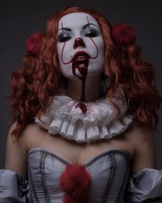 a woman with red hair and makeup is dressed as a clown