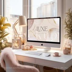 a desktop computer sitting on top of a desk next to a plant and potted plants