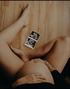 a woman laying on the floor with her legs crossed and two photos in front of her