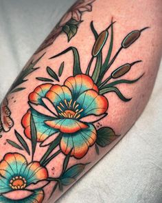 a colorful flower tattoo on the arm