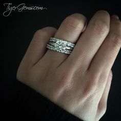 a woman's hand with two wedding bands on her ring and the band is white gold