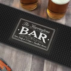 two mugs of beer sitting on top of a table next to a pair of scissors