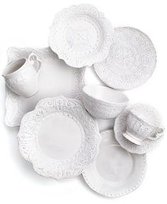 an assortment of white porcelain dishes and cups