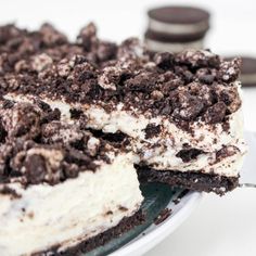 a cake with oreo cookies and cream frosting sitting on top of a plate