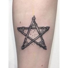 a black and white photo of a star tattoo on the left side of the leg