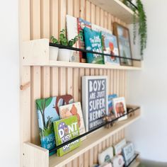 the shelves are filled with books and plants