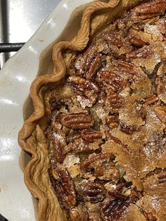 a pecan pie sitting on top of a white plate