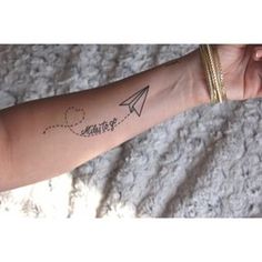 a woman's arm with an airplane and the word sister written on it in cursive writing