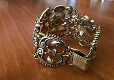 "This is: An original vintage 50s Jewelcraft bracelet. Stunning art nouveau style, with decorative heavy metal links - each signed. Hard to come by, a real rarity. Great condition. Height 5cm 7.5\" length Please see pics for size/weight/condition. Any questions, please message me, thanks. I accept all returns - if you are not happy with your item, please message me before leaving feedback and I will be happy to deal with your concerns. I try my best to be as accurate as possible in my listings, but occasionally I will make a genuine mistake and will rectify it very quickly, just let me know, thanks." Vintage Brass Bracelet With Intricate Design, Vintage Filigree Bracelet Collectible, Vintage Bronze Cuff Bracelet For Formal Events, Vintage Bronze Bracelet For Formal Occasions, Vintage Bronze Bracelets For Formal Occasions, Formal Metal Bracelets With Antique Finish, Vintage Antique Gold Cuff Bracelet, Vintage Brass Cuff Bracelet For Formal Occasions, Vintage Metal Bangle Bracelets