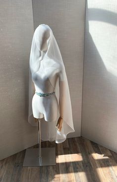 a mannequin wearing a white dress with a veil on it's head