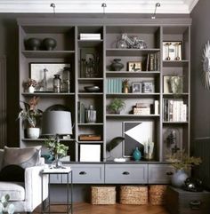 a living room filled with furniture and lots of shelves