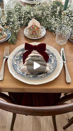 a table set for christmas dinner with plates, silverware and napkins on it