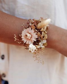 a close up of a person wearing a bracelet with flowers on it's arm