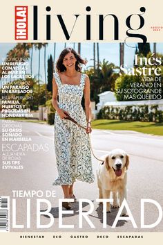 a woman walking a dog on a leash in front of a magazine cover that reads living