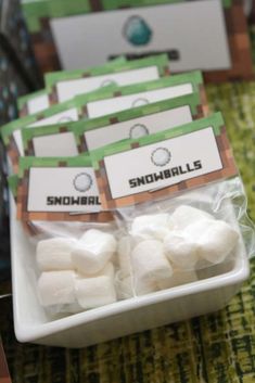 some marshmallows are sitting in a bowl on a table with other items