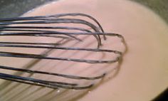 a whisk in a bowl filled with milk