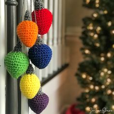 crocheted ornaments hanging from the side of a door next to a christmas tree