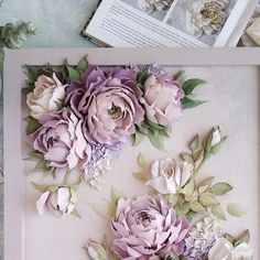 paper flowers are displayed in a shadow box