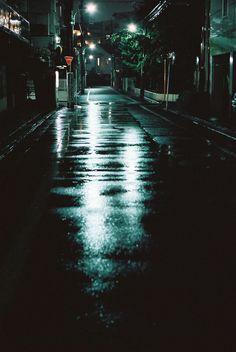 an empty street at night in the rain