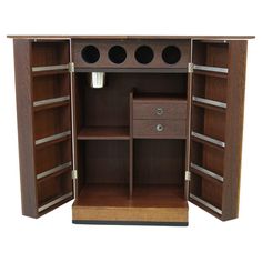 an open wooden cabinet with drawers and shelves