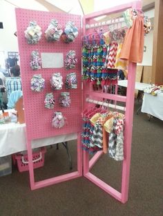 a pink display case filled with lots of baby items