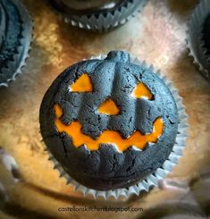 a cupcake decorated like a pumpkin with orange icing