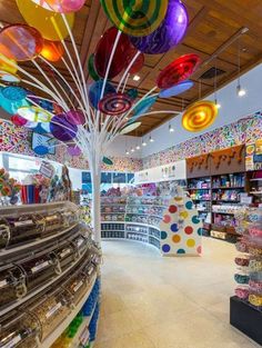 the inside of a store with lots of balloons hanging from the ceiling