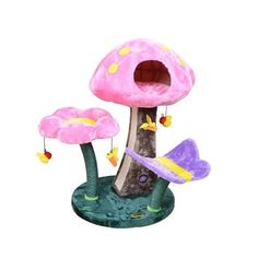 a pink mushroom house with two purple flowers