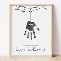 a black and white drawing of a hand holding an umbrella with the words happy halloween written on it