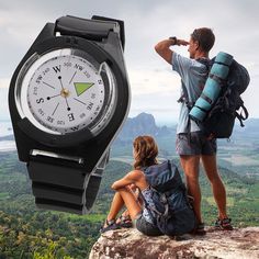 a man and woman sitting on top of a mountain looking at the view from a watch