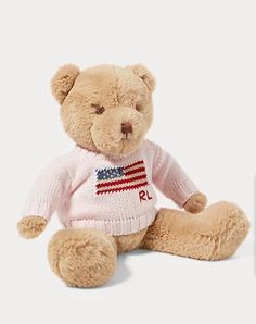 a teddy bear wearing a sweater with the american flag painted on it's chest