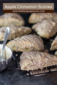 an apple cinnamon scones on a cooling rack with a scoop of icing next to it