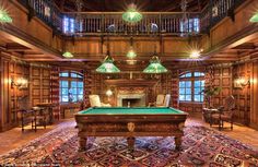 a pool table in the middle of a large room with lots of lights on it