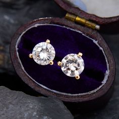 This everyday pair of martini set diamond stud earrings each feature one (1) round brilliant cut diamond in a three-prong setting. The earrings measure 6.4mm wide by 4.6mm deep and are finished with posts and friction backs. Martini Set, Traditional Diamond, Diamond Dangle Earrings, Diamond Stud Earrings, Diamond Stud, Gold Wire, Round Brilliant Cut Diamond, Diamond Earrings Studs, Diamond Studs