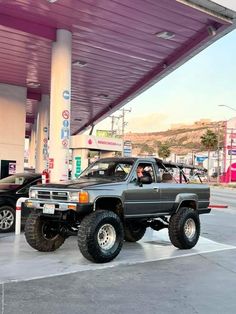 a truck parked in front of a gas station