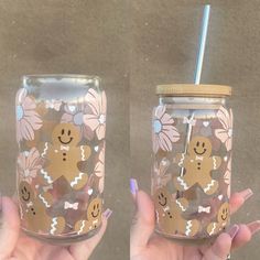 two hand painted mason jars with gingerbreads and flowers, one holding a straw