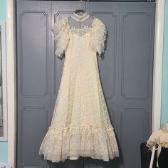 Great Pre-Owned Condition! Vintage Dress! Beautiful Lace Detail On The Whole Dress! It Has Been Very Well Taken Care Of. It's An Off White Cream Color. It Has Buttons And A Zipper On The Back. I Had It Dry Cleaned And It Stays In The Bag Other Than To Take These Photos. Wedding Dress. Evening Gown. Evening Dress. White Christmas. Vintage Historic Dress. Larping. Pride And Prejudice. Tea Dress. Neck To Waist: 16 1/4" Neck To Bottom: 58" Bottom Trim: 11" Waist: 13" (Side To Side) Chest: 16" (Armpit To Armpit) Belt: 29.5" Questions? Leave A Comment Below! I Love Reasonable Offers And Bundles! Make Me An Offer! California Wedding Dress, Wedding Dress Size 10, Wedding Dress Evening, Side Chest, Dress Neck, Christmas Vintage, Photos Wedding, Historical Dresses, Dress Evening