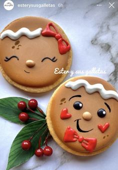 two decorated cookies sitting on top of a table