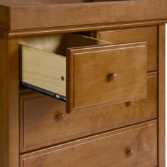 a wooden dresser with two drawers and an open drawer