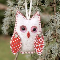 an owl ornament hanging from a tree