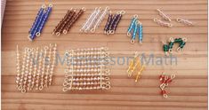 several pieces of beaded jewelry laid out on a wooden table with scissors and beads