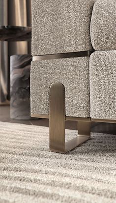 a close up of a metal object on the ground in front of a couch and coffee table